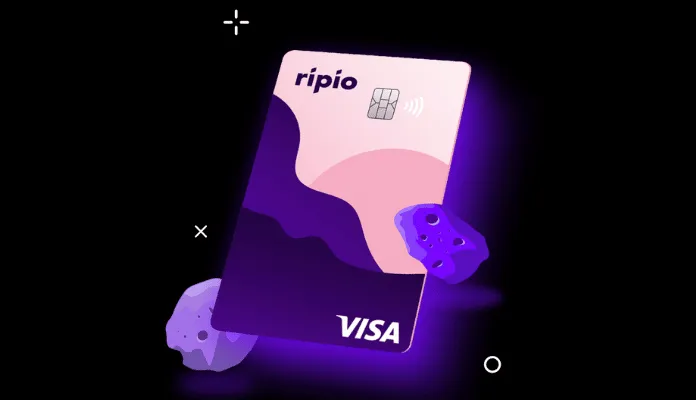 The image shows a stylized digital illustration of a Ripio Visa card. The card features a pink and purple abstract wave design with the “ripio” logo at the top left and a Visa logo at the bottom right.