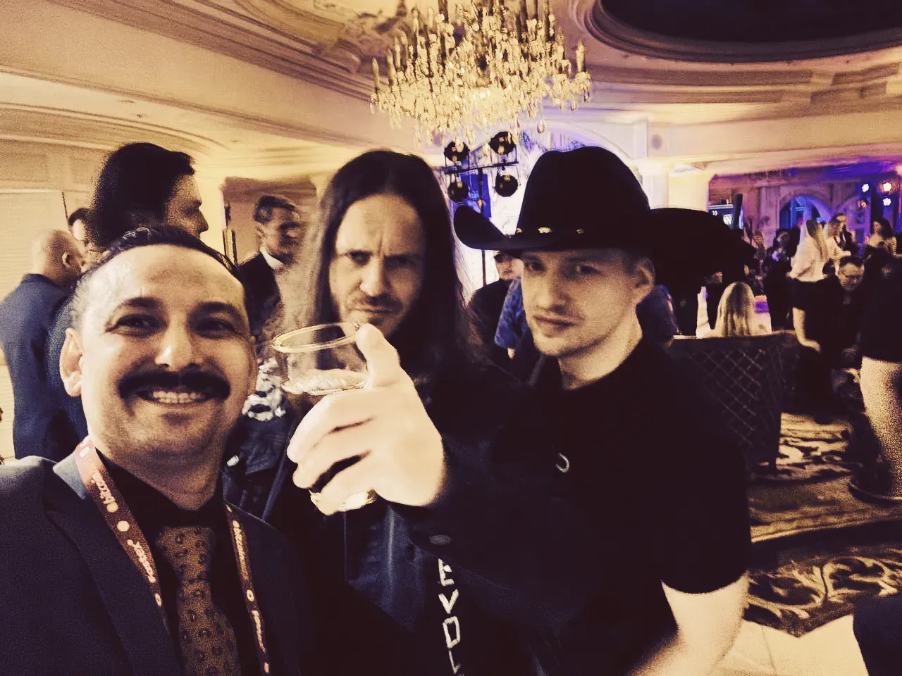 Three men at a Bitcoin 2025 conference, with two smiling.